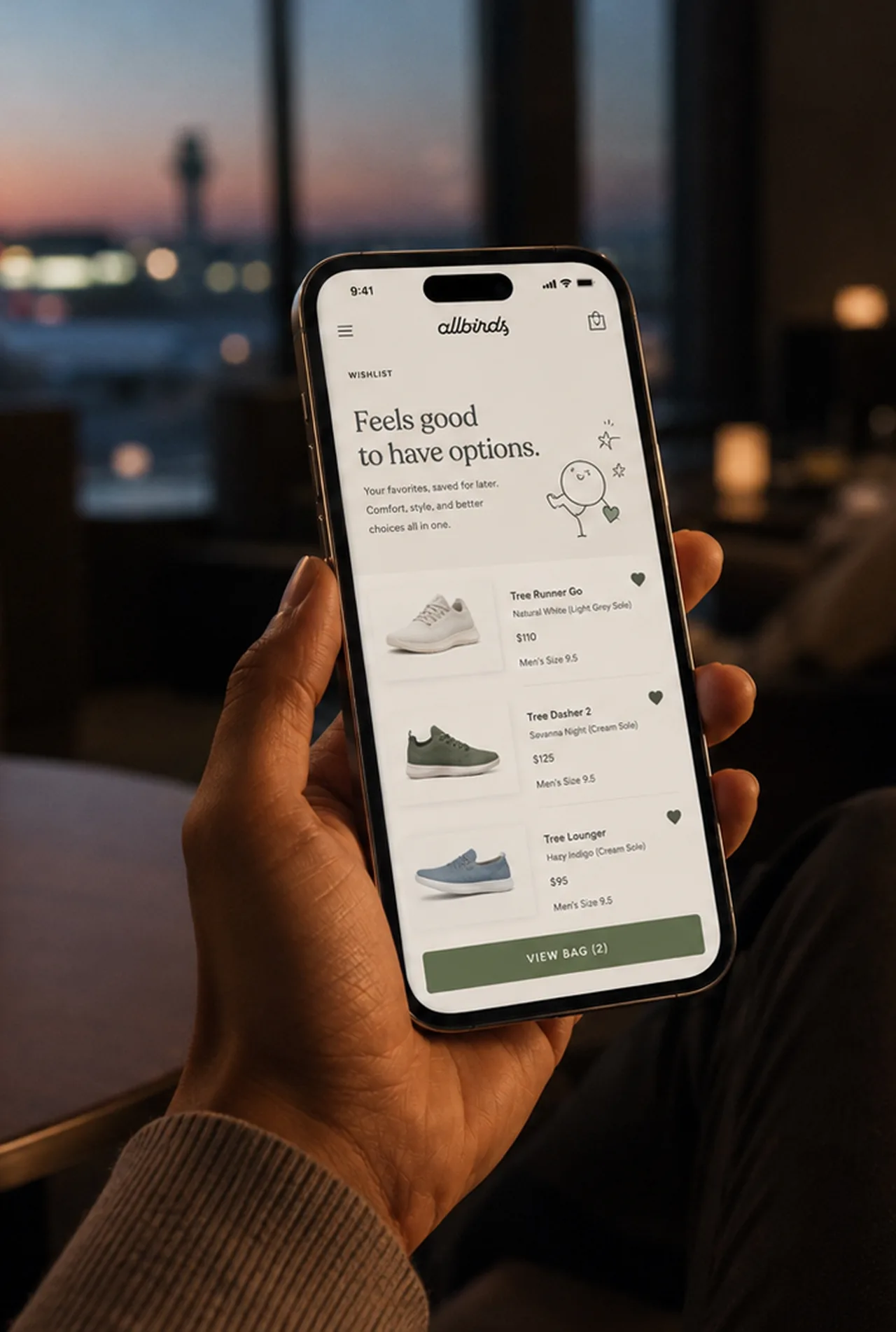Allbirds — App wishlist screen held in an airport lounge
