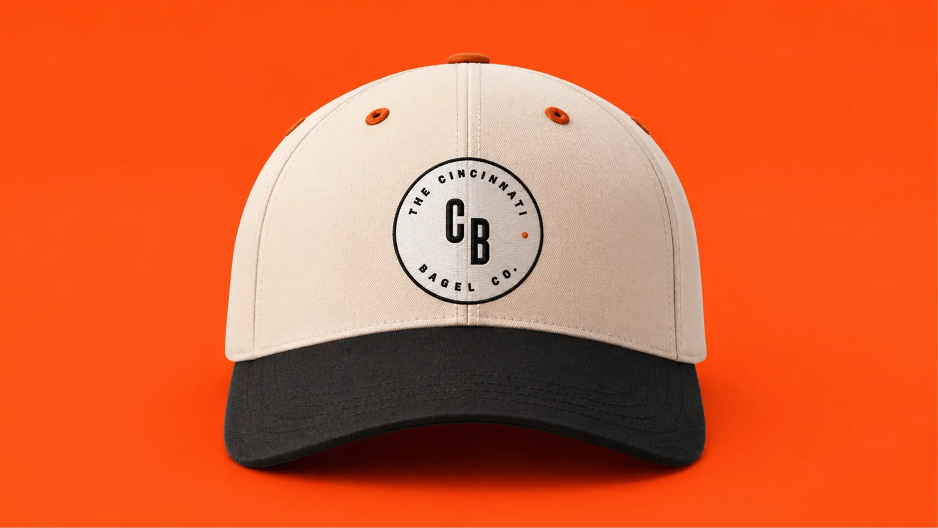 The Cincinnati Bagel Co. — A Cincinnati Bagel Co. cap on an orange background