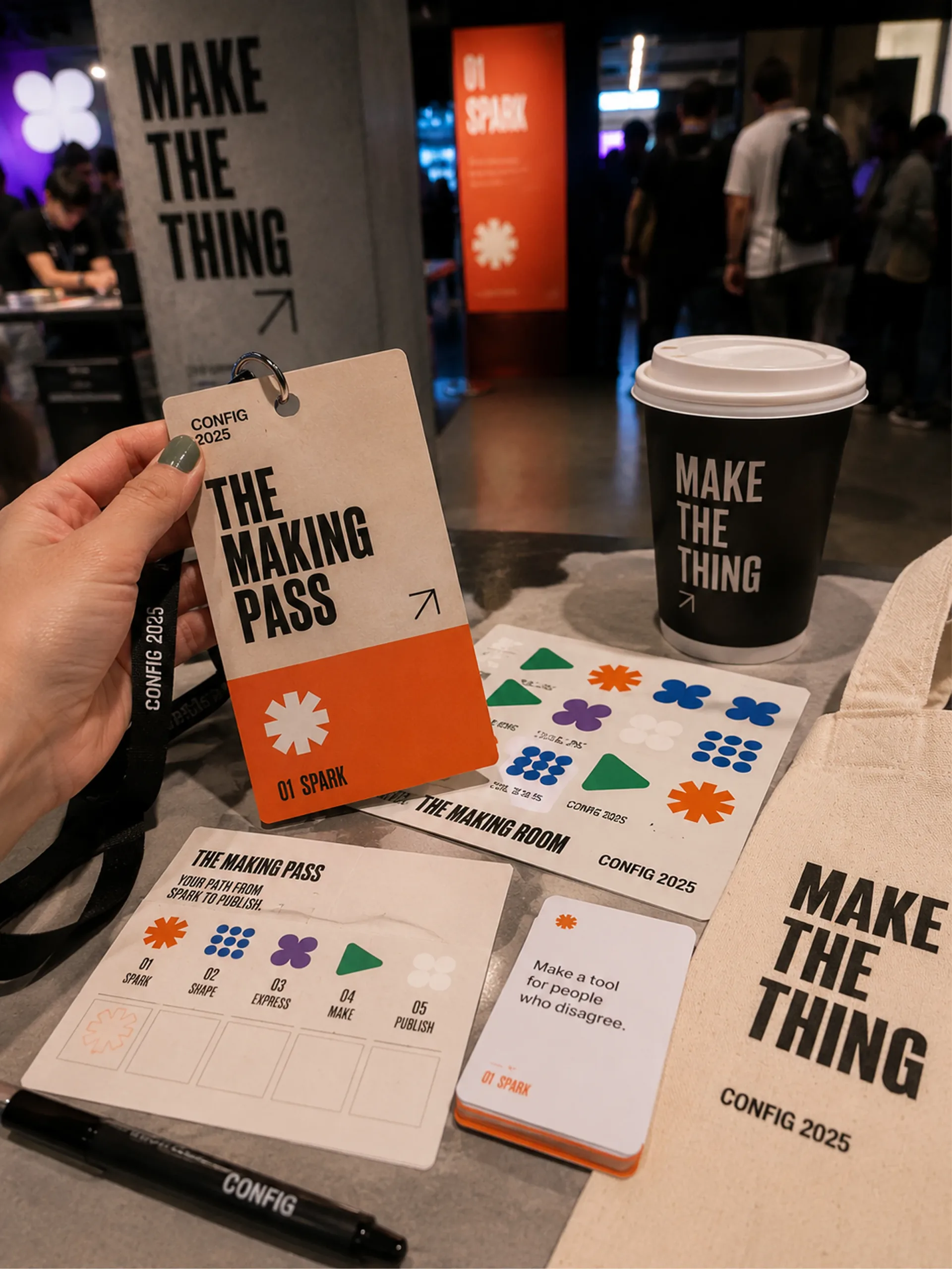 Config 2025 — Config 2025 Making Room pass, coffee cup, guide, phone, and printed activity materials on a table