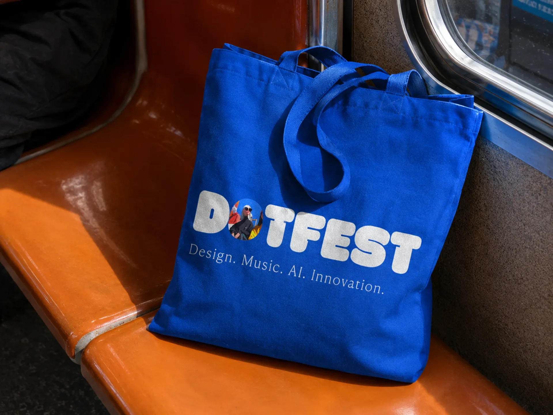 Dot Fest — Dot Fest blue tote bag on an orange metro seat