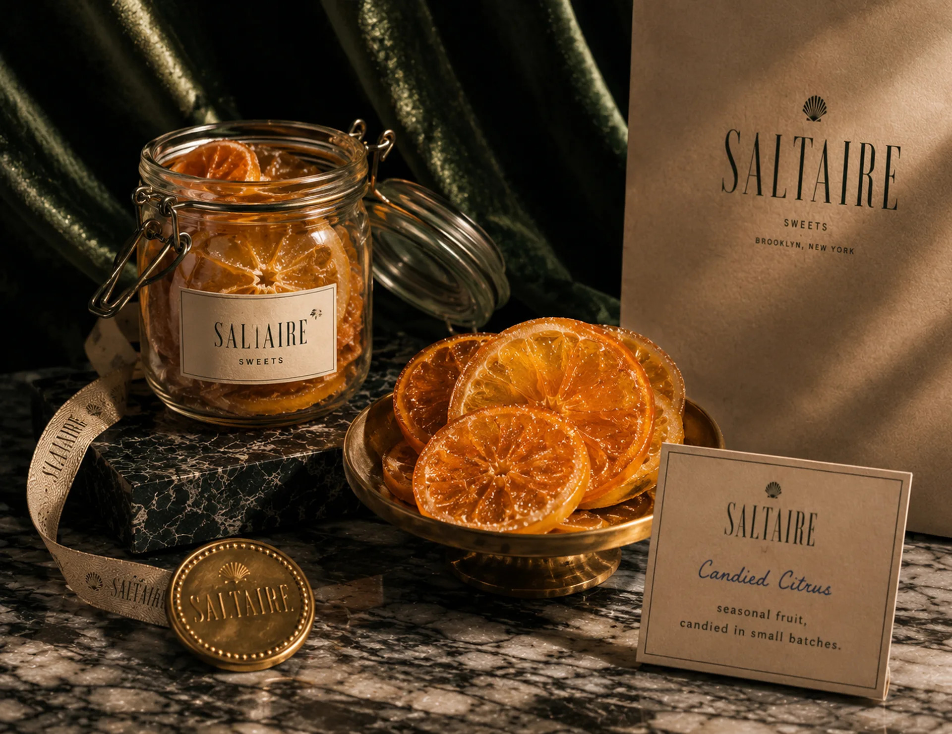 SALTAIRE — A jar of SALTAIRE candied citrus with dried orange slices, a product card, receipt slips, and gold seals