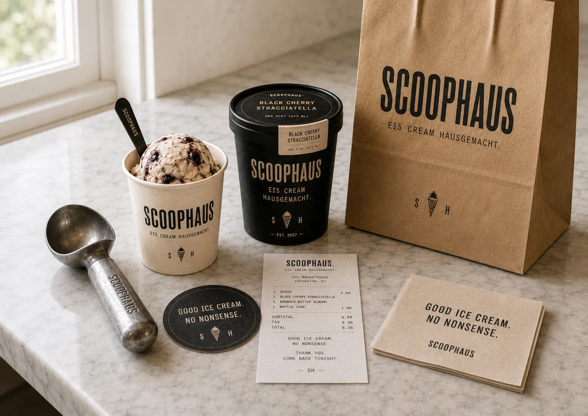 Scoophaus — Scoophaus takeaway kit with white cup, black pint, kraft bag, scoop, receipt, and printed card
