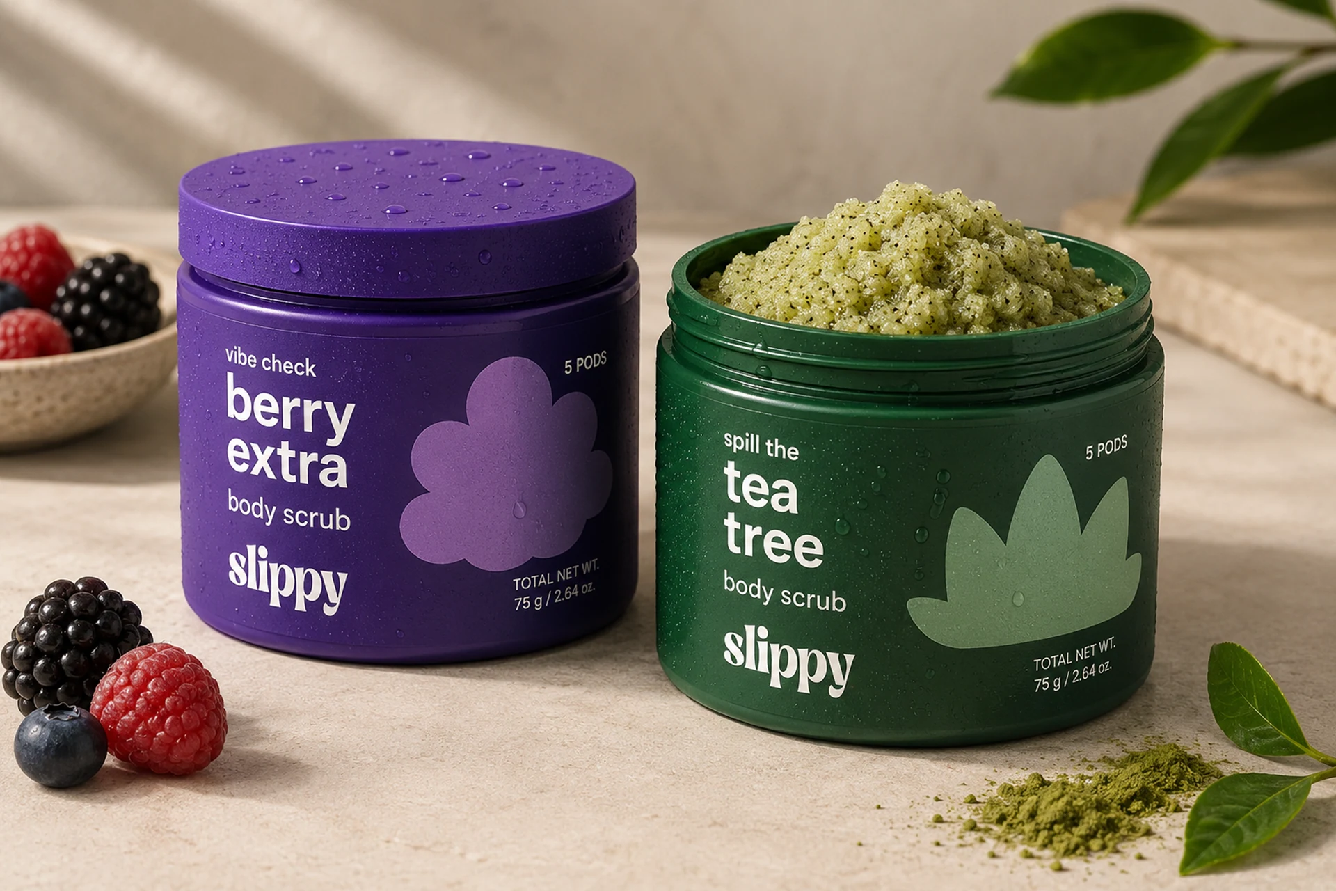 Slippy scrub jars showing the berry extra and tea tree textures, scent names, and tactile wet packaging