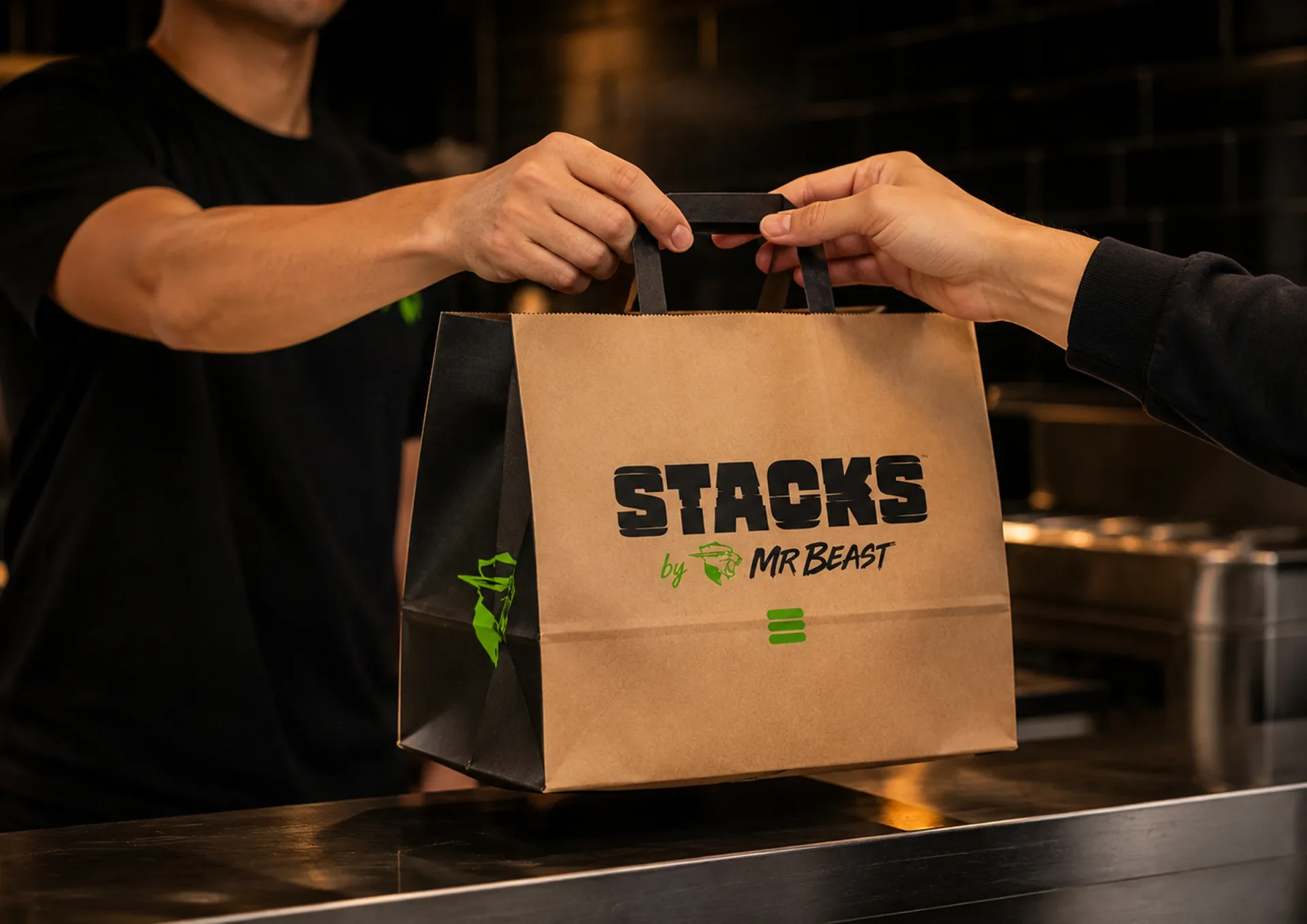 Stacks — Stacks kraft takeaway bag handed across a restaurant counter