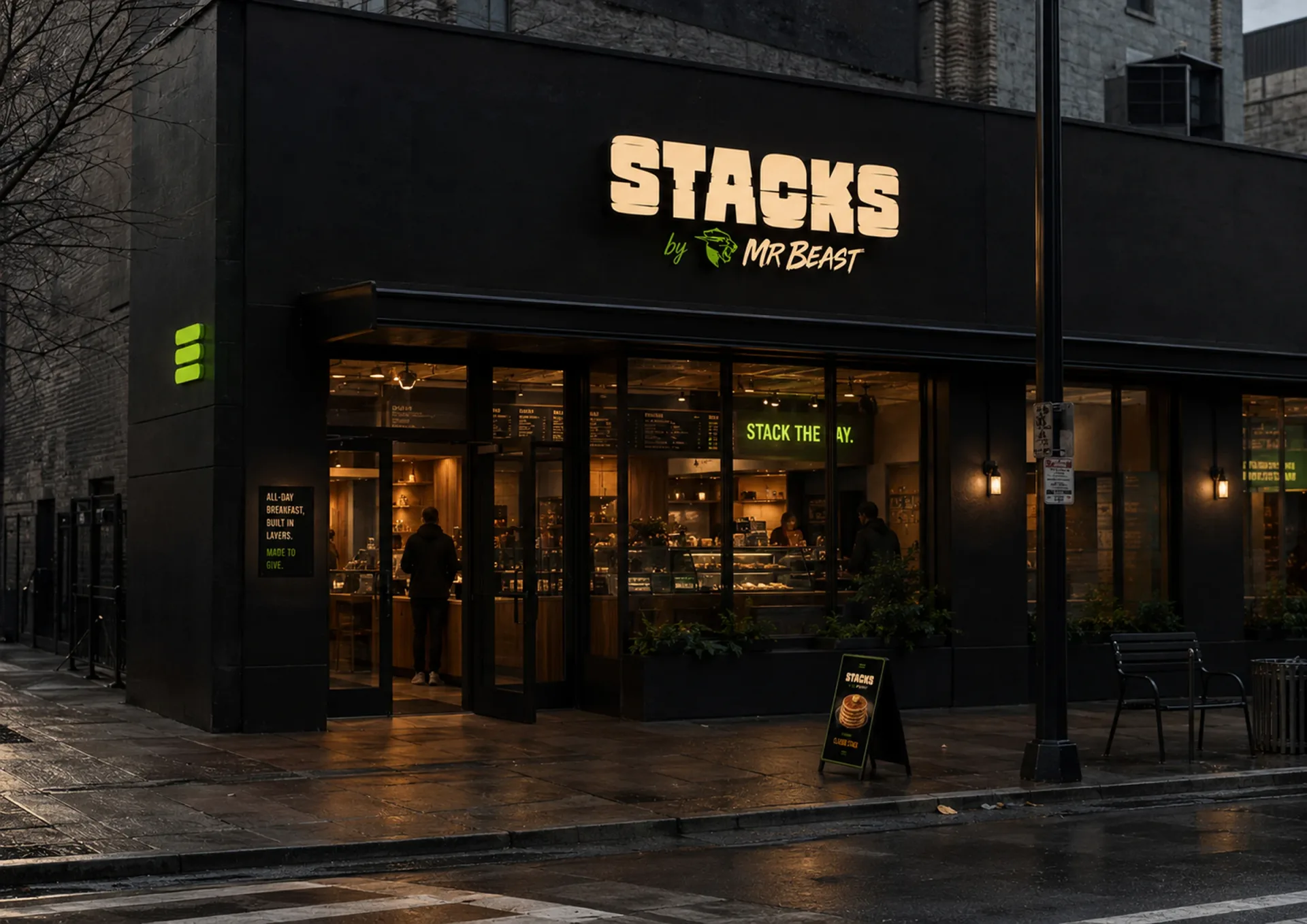 Stacks — Stacks by MrBeast storefront at night with black facade, glowing sign, pickup window, and sidewalk board