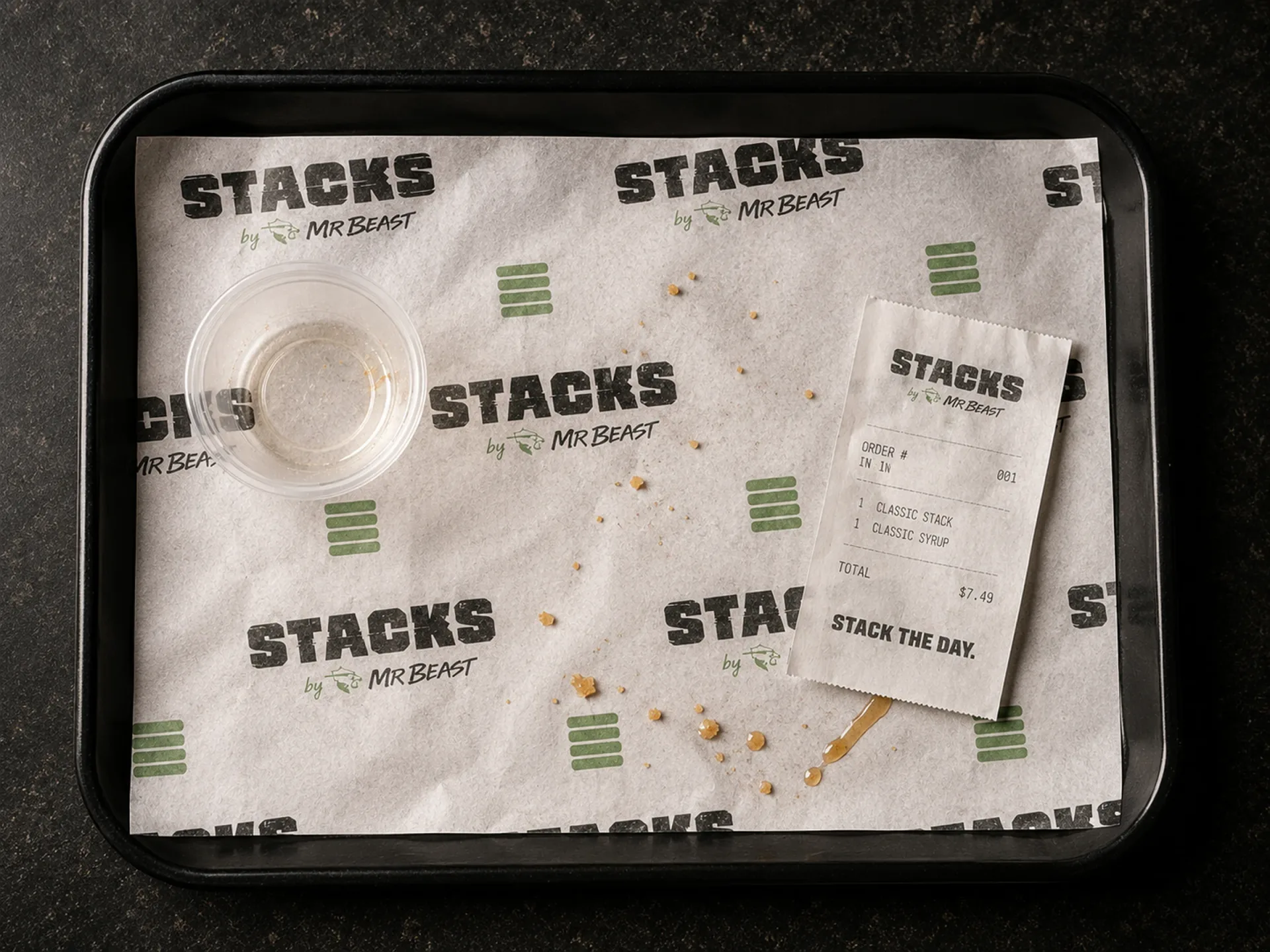 Stacks — Stacks branded wrap paper, sauce cup, and receipt on a black service tray